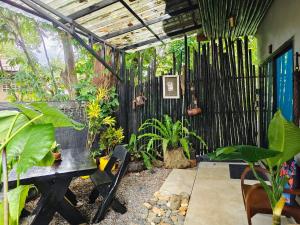 a garden room with a bench and plants at Green Valley Lodge in Khao Sok National Park