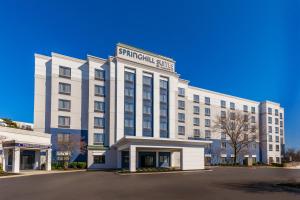 a large white building with a sign on it at SpringHill Suites Boston Peabody in Peabody