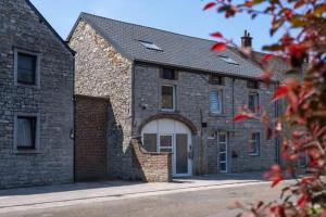 a brick house with a white garage at L'aparté in Rochefort