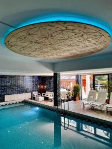 a pool in a hotel with a circular ceiling at Bergsteiger-Zimmer Pension Obermair in Mayrhofen