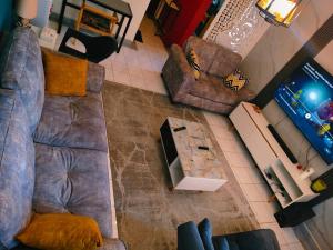 an overhead view of a living room with a couch and chairs at Greatwall Apartment in Syokimau
