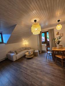 a living room with a couch and a table at LS Apartments Štefanová in Terchová