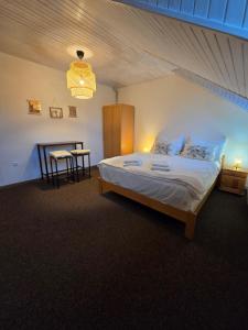 a bedroom with a large bed and a table at LS Apartments Štefanová in Terchová