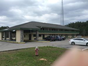 a building with cars parked in a parking lot at Days Inn by Wyndham York Alabama in York