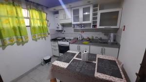 a small kitchen with a table and a sink at Rosibel in Río Ceballos +8 photos