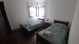 a bedroom with two beds and a window at Rosibel in Río Ceballos