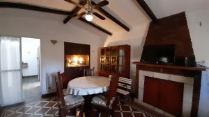 a living room with a table and a fireplace at Rosibel in Río Ceballos
