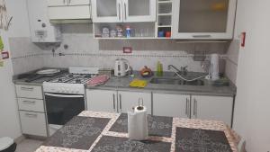 a small kitchen with a stove and a sink at Rosibel in Río Ceballos