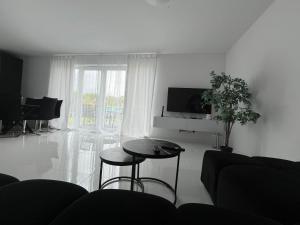 a living room with a table and a tv at DOM LAGOWSKI z SAUNA in Łagów