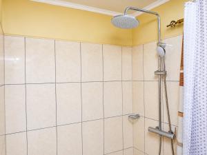 a shower with a shower head in a bathroom at JAC Tilama BNB Villa-3 Bedroom in Blantyre