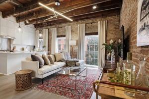 a living room with a couch and a table at Luxe 8BR CBD Duplex Private Courtyard in New Orleans