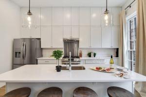 a kitchen with white cabinets and a white counter top at Luxe 8BR CBD Duplex Private Courtyard in New Orleans