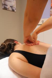a woman in a black bikini laying on a bed at Hotel SPA GBC Avenida Pontevedra in Pontevedra