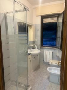 a bathroom with a shower and a sink and a toilet at La casa di RÒ in Avegno +11 photos