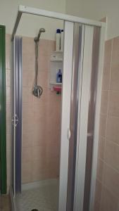 a shower with a glass door in a bathroom at Casa Panorama in Senigallia