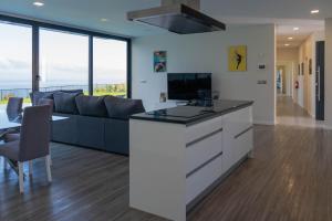 a living room with a couch and a table at Luna Villa in Campanário