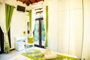a living room with a bed and a balcony at Regal Retreat in Mahawatta