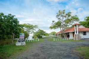 a building with a sign next to a road at Regal Retreat in Mahawatta