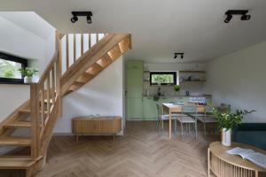 a living room with a staircase and a table at Leśne Chwile in Osiek
