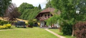 a house with a garden and a grass yard at Kļūda 2 in Biksinīki