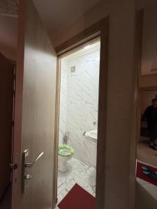 a bathroom with a shower and a toilet and a sink at Sunset Stay Anza in Agadir