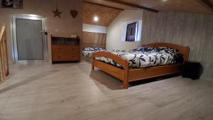 a bedroom with two beds and a dresser and a door at Chez Nova in Chaudenay