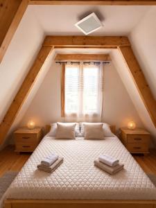 a bedroom with a bed in the attic at Holiday Home Stefani Spacious Mountain House near Durmitor 3 Bedrooms Private Parking in Žabljak