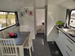 a kitchen and dining room with a table and chairs at Rem'Ann boat in Briare