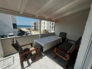 a balcony with a table and chairs and a view of the ocean at Villa LIR in Vir