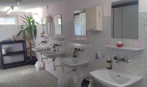 a bathroom with two sinks and two mirrors at Jurte Falkenauge Schweiz in Schönengrund +7 photos