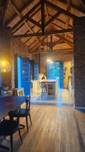 a large room with a table and chairs and a kitchen at Casa 80 in Monte Belo