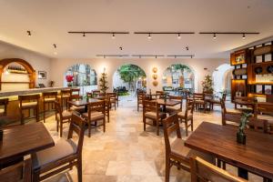 a restaurant with wooden tables and chairs at New Hotel Serenata Santa Lucia Mérida in Mérida