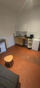 a room with a kitchen with a table and a counter at Olti in Avignon +7 photos