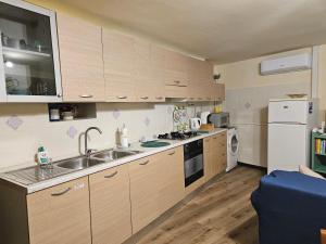a small kitchen with a sink and a refrigerator at Locazione Turistica LBS, San Giacomo , Spoleto in San Giacomo +16 photos
