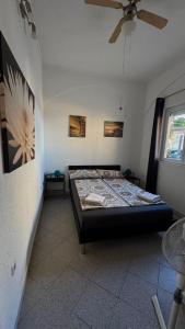 a bedroom with a bed and a ceiling fan at Villa LIR in Vir