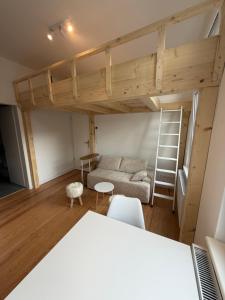 a living room with a couch and a loft bed at Inselquartier Ratzeburg in Ratzeburg