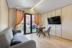 a living room with a couch and a table at Басейн Чан с Джакузи Дом Посуточно Осокорки Киев in Kyiv