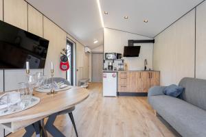 a living room with a dining table and a kitchen at Басейн Чан с Джакузи Дом Посуточно Осокорки Киев in Kyiv