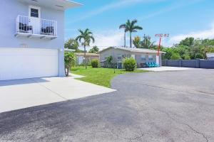 a white house with a driveway in front of it at Mayas Blue Lagoon Luxury Suite #2 in Fort Lauderdale