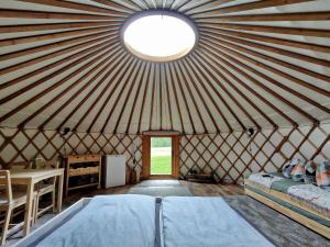 a large yurt with a bed and a window at Jurte Falkenauge Schweiz in Schönengrund