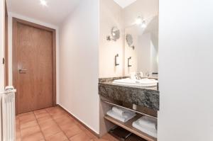 a bathroom with a sink and a mirror at Apartaments VM Molleres in Soldeu +12 photos