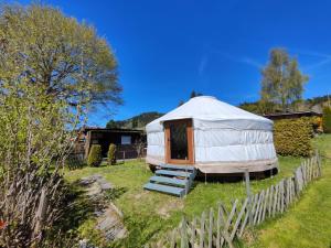 a yurt in a yard with a fence at Jurte Falkenauge Schweiz in Schönengrund