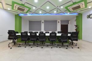 a conference room with a long table and black chairs at Hotel Pearl Heritage in Jaipur