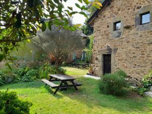 a picnic table in the grass next to a building at Vega in Muñás