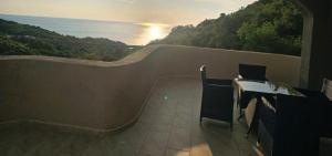 a balcony with a view of the water at Apartmani Zara in Pečurice +15 photos
