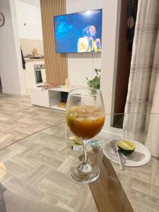 a drink in a glass sitting on a table at Appartement Kazalya in Sainte-Rose +2 photos