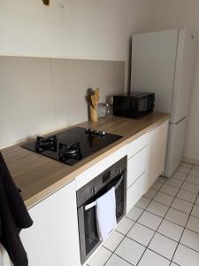 a kitchen with a stove and a stove top oven at Appartement Kazalya in Sainte-Rose