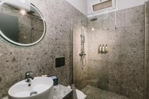 a bathroom with a sink and a shower at Nomad apartment in Chóra +18 photos