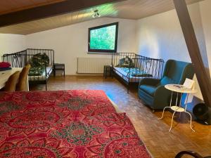 a room with three beds and a red rug at Amselhof Kördorf in Kördorf