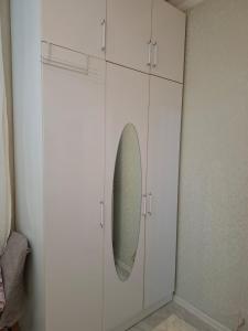 a white cabinet with a mirror in a room at 2-Room Modern House in Naxçıvan